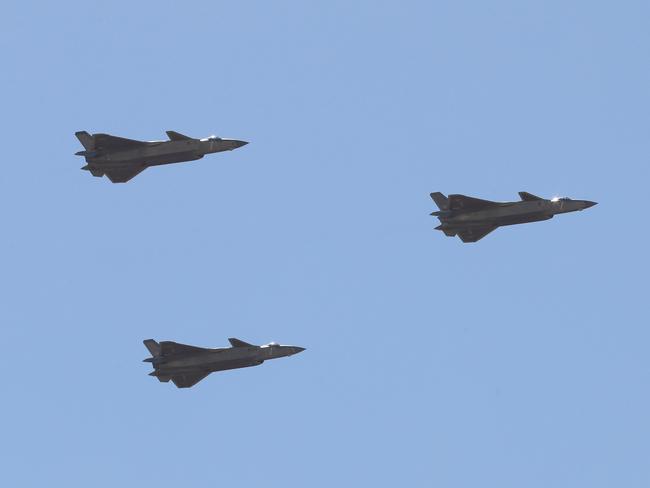 A flight Chinese J-20 stealth fighter jets fly past during a military parade at the Zhurihe training base in China's northern Inner Mongolia region on July 30, 2017. Picture: AFP