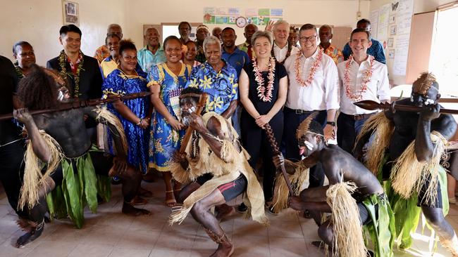 Tribal dancers entertain Foreign Minister Penny Wong, centre, and her fellow delegates and local dignitaries in Port Vila.