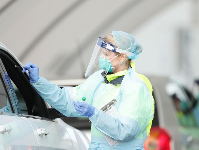 SYDNEY, AUSTRALIA - JULY 07: Medical professionals conduct a nasal swab test at the COVID-19 Bondi Beach drive-through testing center on July 07, 2020 in Sydney, Australia. Coronavirus testing continues across NSW as the state recorded seven new cases of COVID-19 in the past 24 hours. Six of the new cases are returned travellers in hotel quarantine, while the seventh is a recently returned traveller who tested negative while in quarantine but developed symptoms once he returned home. NSW Health has also increased testing in the regional town of Albury on Tuesday, after two positive COVID-19 cases were confirmed in the area. One of the people who returned a positive rest recently travelled to Melbourne. (Photo by Mark Metcalfe/Getty Images)