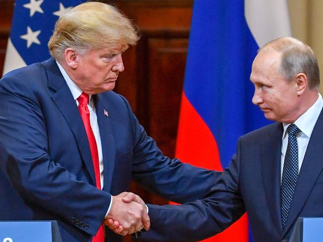 US President Donald Trump (L) and Russia's President Vladimir Putin shake hands before attending a joint press conference after a meeting at the Presidential Palace in Helsinki, on July 16, 2018. The US and Russian leaders opened an historic summit in Helsinki, with Donald Trump promising an 