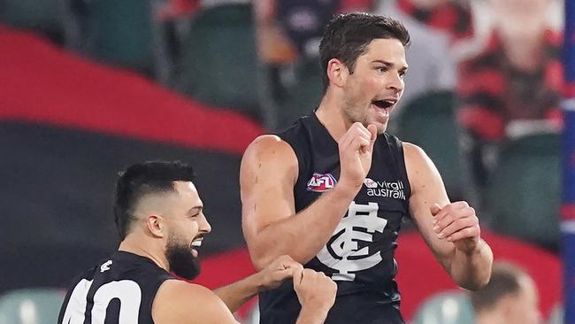 Levi Casboult of the Blues celebrates a goal with Michael Gibbons during the Round 4 AFL match between the Essendon Bombers and the Carlton Blues at the MCG in Melbourne, Saturday, June 27, 2020. (AAP Image/Michael Dodge)