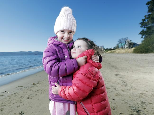 Sisters Zara, 5, and Gigi White, 3, of Sandy Bay, enjoy the weather at Nutgrove Beach. Picture: ZAK SIMMONDS