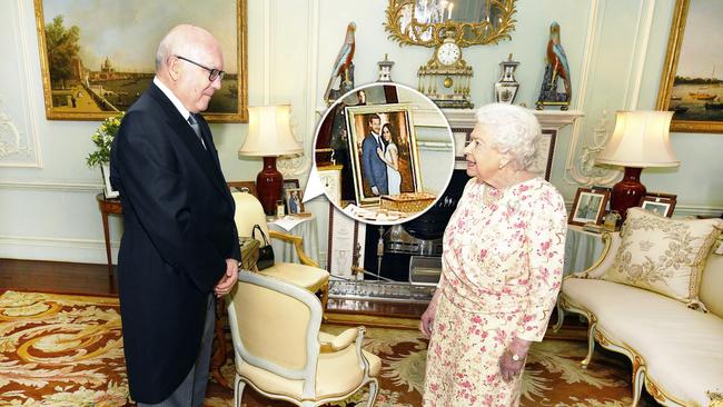 The photograph of Harry and Meghan is in pride of place on a side table in the Audience Room as Queen Elizabeth II talks with George Brandis. Picture: AP.