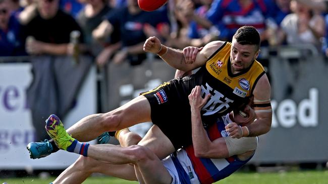 Werribee Districts’ Andrew Panayi is tackled by Point Cook’s Nicholas Buykx. Picture: Andy Brownbill