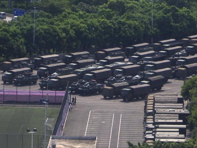 The People’s Liberation Army has gathered paramilitary vehicles and troops at the border city of Shenzen. Picture: AP