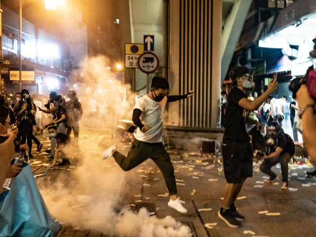 A protester attempts to kick a tear gas canister during a demonstration on Hungry Ghost Festival day in Sham Shui Po district in Hong Kong. Picture: Getty Images