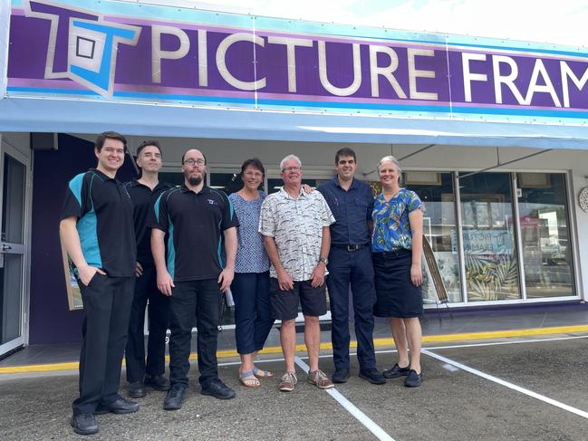 TJ Framing staff Kinsley Franklin, Michael Jones, and David Gillespe with founders Terese and James Marrs and new owners Rod and Cindy Lawn. Photo: Zoe Devenport