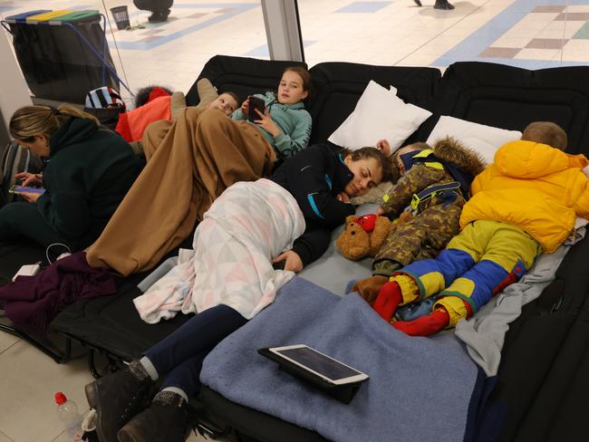 Women and children who have fled from war in Ukraine rest at a temporary shelter set up in a former shopping centre in Przemysl, Poland. Picture: Getty Images