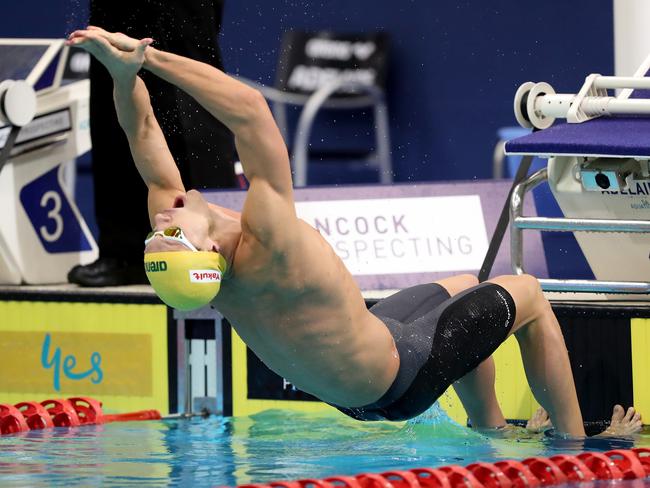 Mitch Larkin launches off the blocks during the Men’s 100m Backstroke final. Picture: AAP Image/James Elsby