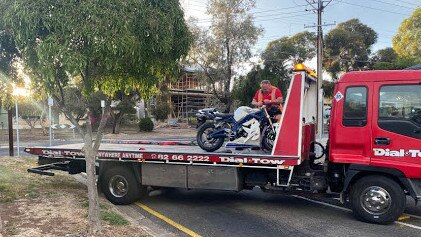 The motorcycle involved in a fatal crash is removed from the scene at Enfield.