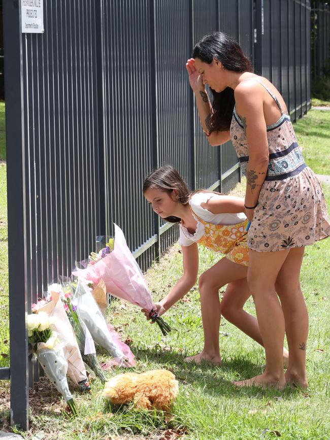 Locals drop off a floral tribute at Tweed Heads Public school for Charlise Mutten. Picture Glenn Hampson