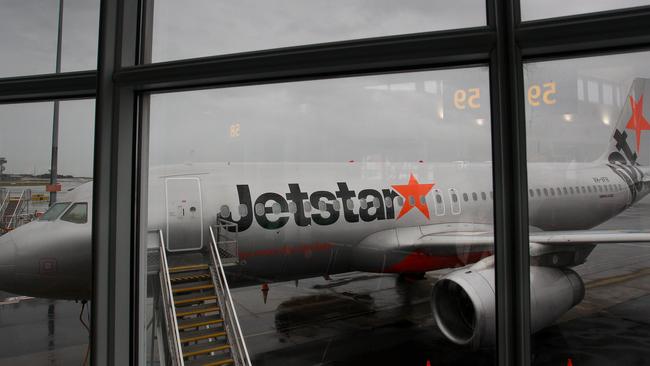 A Jetstar aircraft at the Sydney Domestic Airport Terminal on August 7. Boarding students returning home to NSW from Victoria face lenghthy trips from Melbourne to Sydney Airport under strict new border restrictions. Picture: Lisa Maree Williams/Getty Images