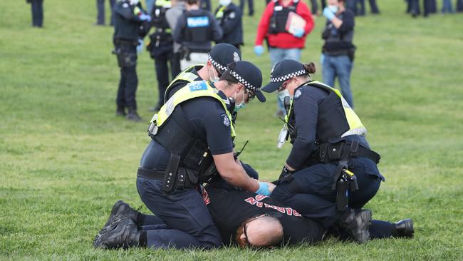 Police arrest a man at Northcote’s All Nations Park. Picture: David Crosling