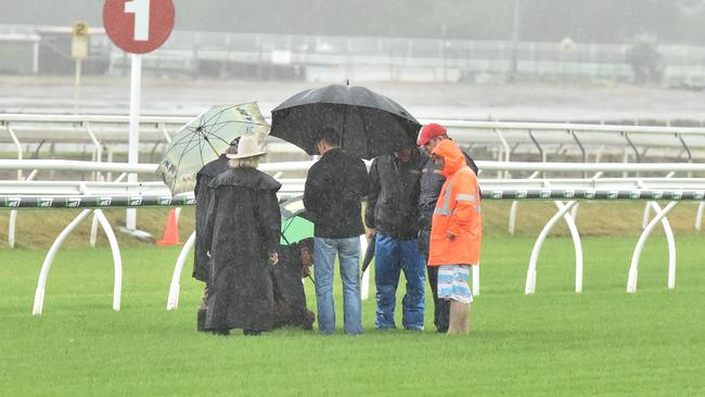 Stewards and officials inspect the Eagle Farm track on Saturday. Picture: Grant Peters