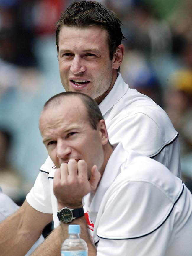 Injured stars Matthew Primus and Josh Francou watch Port Adelaide’s 2004 grand final win from the sidelines. 