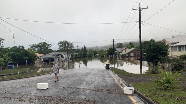 Elwyn Paddison, 80, surveys flood damage to his home at the intersection of Hunter Street and McKenzie Street in Lismore on March 1, 2022.