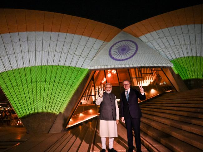 SYDNEY, AUSTRALIA - MAY 24: India's Prime Minister Narendra Modi (L) and Australian Prime Minister Anthony Albanese pose in front of the sails of the Sydney Opera House illuminated in the colours of the Indian flag on May 24, 2023 in Sydney, Australia. Modi is visiting Australia on the heels of his and Australia's Prime Minister Anthony Albanese's participation in the G7 Summit in Japan. (Photo by Dean Lewins-Pool/Getty Images)