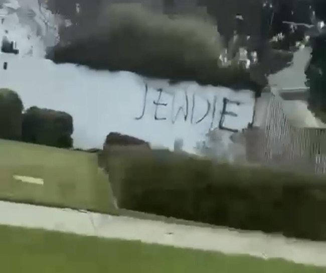 The words 'Jew die' graffitied on the front fence of Mount Scopus' Burwood campus on Saturday, May 25, 2024.