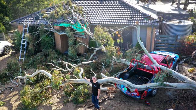 A tree down on a house and vehicle at Kyneton in Victoria. Picture: Alex Coppel.