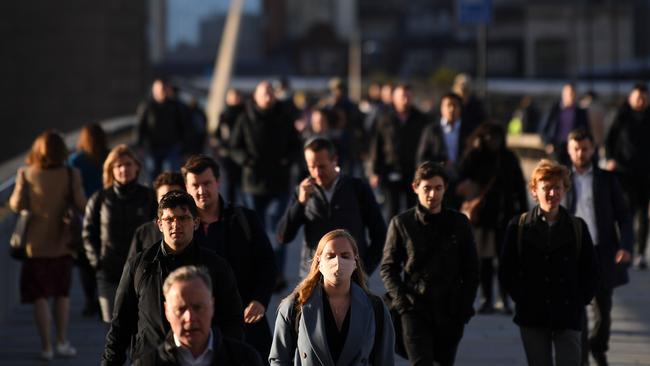 Commuters walk over London Bridge toward the City of London during the morning rush hour. Prime Minister Boris Johnson on October 14 said a new UK-wide lockdown would be a “disaster” but refused to rule it out. Picture: Daniel Lwal-Olivas/AFP