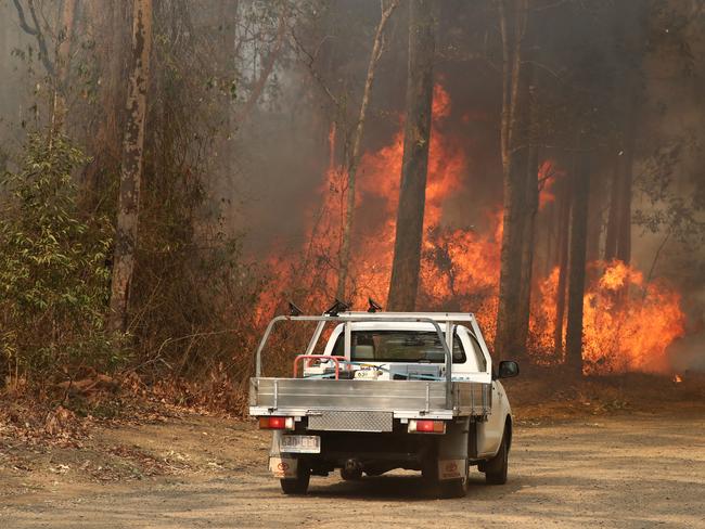 Firefighters battle bushfires in Busbys Flat, northern NSW, Wednesday, October 9, 2019. (AAP Image/Jason O'Brien)