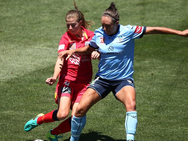 Emily Hodgson of Adelaide United and Kyah Simon of Sydney compete for the ball last season.