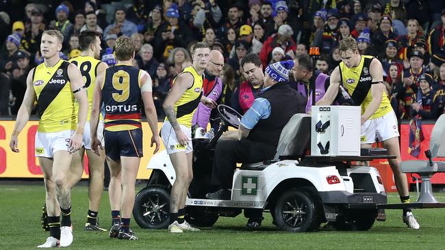 Adelaide and Richmond players check on Josh Jenkins’ welfare. Picture SARAH REED