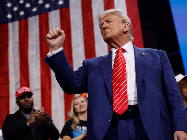 ATLANTA, GEORGIA - OCTOBER 15: Republican presidential nominee, former U.S. President Donald Trump raises his fist after delivering remarks during a campaign rally at the Cobb Energy Performing Arts Centre on October 15, 2024 in Atlanta, Georgia. With early voting starting today in Georgia both Trump and Democratic presidential nominee, Vice President Kamala Harris are campaigning in the Atlanta region this week as polls show a tight race.   Kevin Dietsch/Getty Images/AFP (Photo by Kevin Dietsch / GETTY IMAGES NORTH AMERICA / Getty Images via AFP)