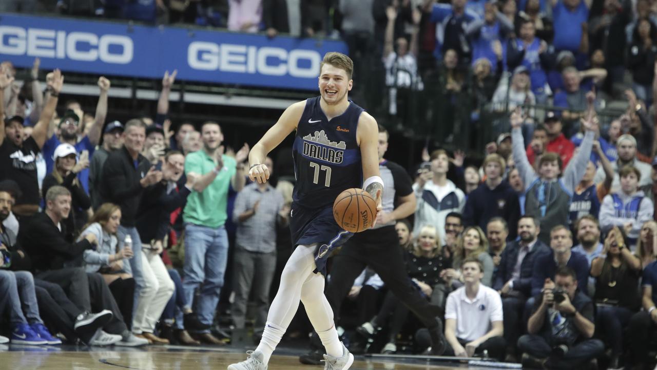 Dallas Mavericks forward Luka Doncic smiles as time expires against the Pelicans.