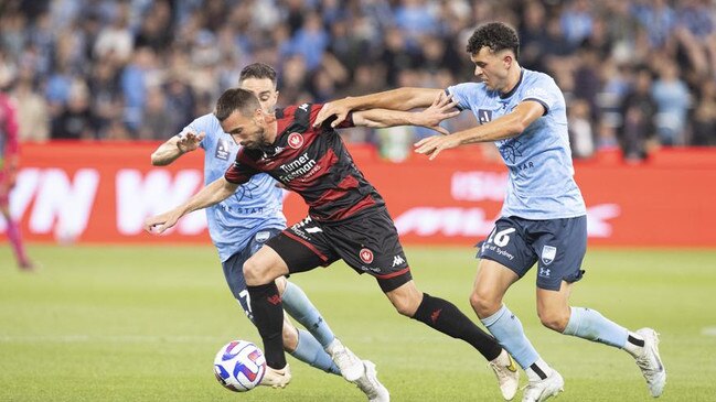 Romain Amalfitano of the Wanderers is tackled by Sydney FC's Patrick Yazbek and Anthony Caceres during the round six A-League Men's match between Sydney FC and Western Sydney Wanderers at Allianz Stadium. Photo: Steve Christo - Corbis/Corbis via Getty Images