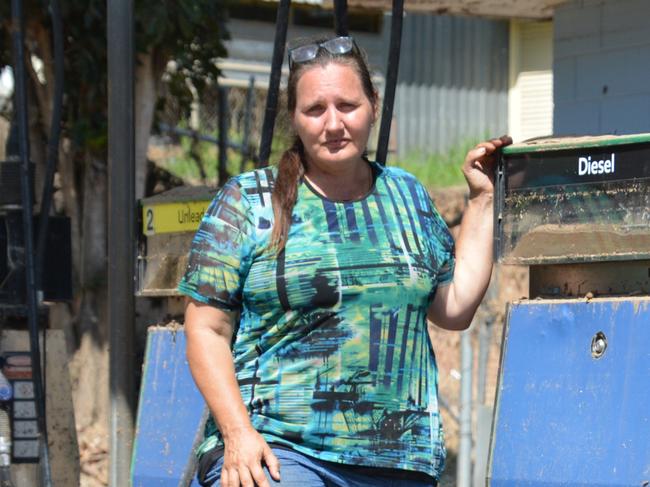 Wujal Wujal Aboriginal Shire chief executive Kiley Hanslow. pictured at the ruins of the town's petrol station, and her partner Lawrence Fry are the only residents left in town since the evacuation following the flood. Picture: Bronwyn Farr