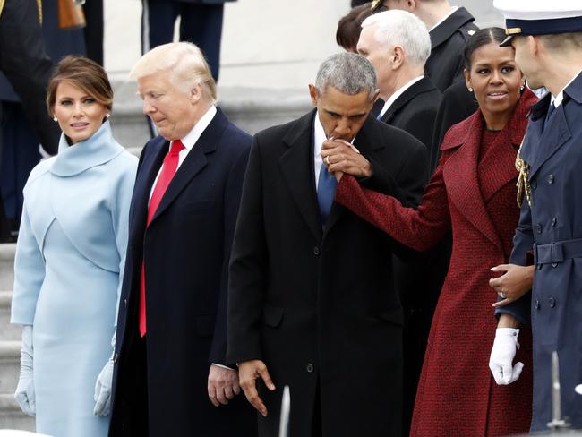 First lady Melania Trump stands with President Donald Trump as former President Barack Obama kisses the hand of his wife Michelle Obama, during a departure ceremony on the East Front of the U.S. Capitol on January 20, 2017 in Washington. Picture: AP