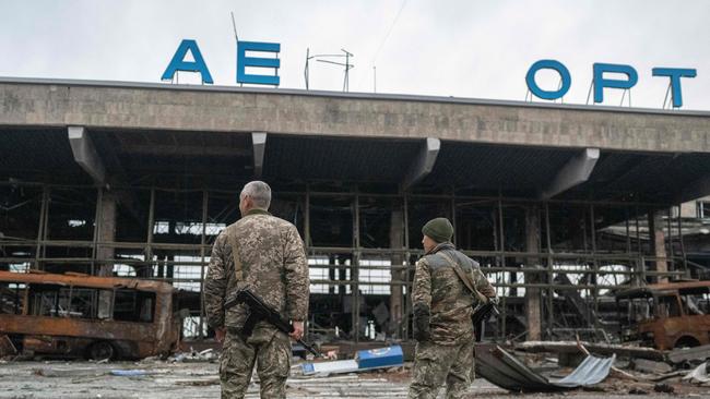 Ukraine soldiers stand in front of a destroyed building at the International Airport of Kherson in the village of Chornobaivka. Picture: AFP