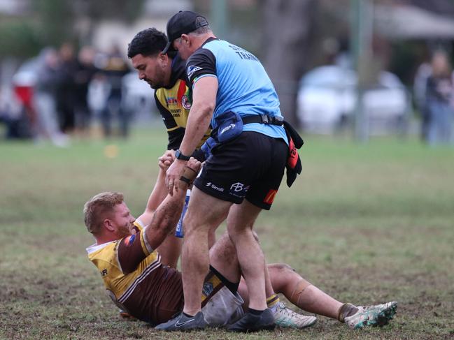 Will Broadhead is helped off the turf. Picture Warren Gannon Photography