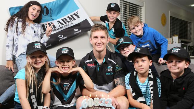 The Ferrari family celebrate the Power’s record membership at home with Port Adelaide player Hamish Hartlett, friends and family, from left, Madeline Leaney, Michaela Ferrari, Avah Beracci, Hudson King, Anthony Beracci, David Ferrari, Helga Ferrari, James Outlines, Daniel Ferrari, Jasmin Leaney and Jayden King. Picture: AAP/Emma Brasier