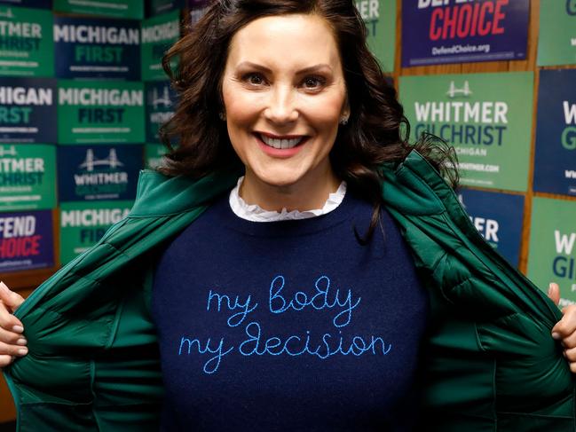 Michigan State Governor Gretchen Whitmer shows a "My Body My Decision" shirt at the 14th District Democratic Headquarters, during the US midterm election in Detroit, Michigan, on November 8, 2022. (Photo by JEFF KOWALSKY / AFP)