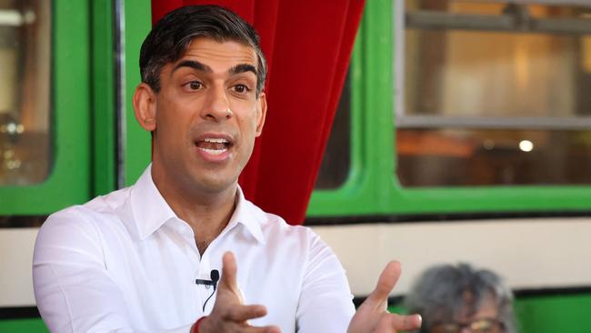 Rishi Sunak visits a fish processing plant in England’s Leigh-on-Sea. Picture: AFP