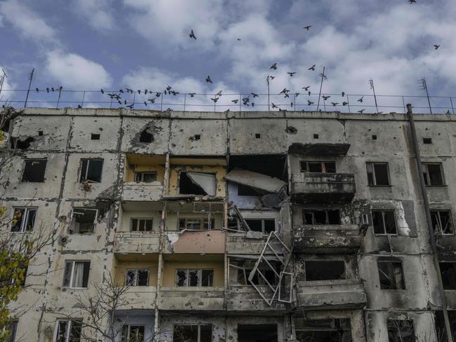 Birds fly over a damaged building in the Kherson region village of Arkhanhelske, which was formerly occupied by Russian forces. Picture: AFP