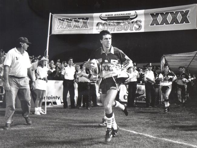 Laurie Spina leads the North Queensland Cowboys on to the field for their first game in 1995.