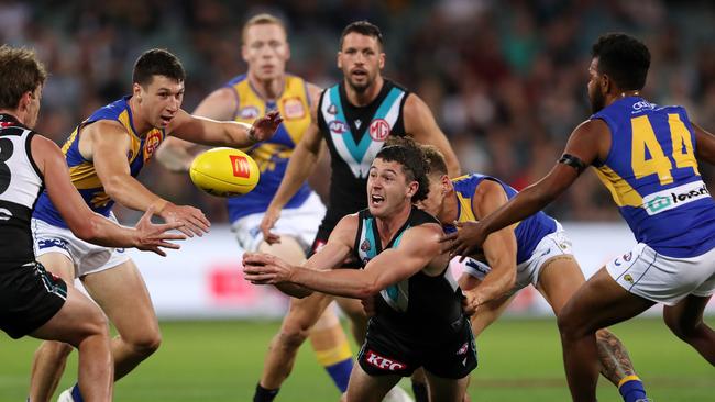 Darcy Byrne-Jones fires out a handpass. Picture: Sarah Reed/AFL Photos