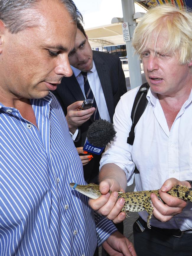 2013: Then London Mayor now British Prime Minister Boris Johnson with George the royal baby crocodile at Darwin Airport with then NT Chief Minister and now probably game show host Adam Giles. Picture: Elise Derwin