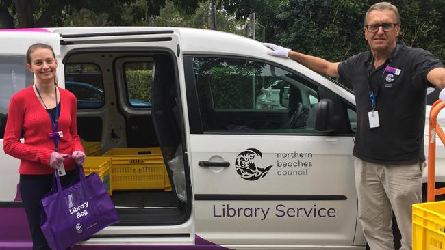 Librarian Holly Auld, left, helping load the van with driver John Farrell for Northern Beaches Council's new Library2U service. Picture: Northern Beaches Council