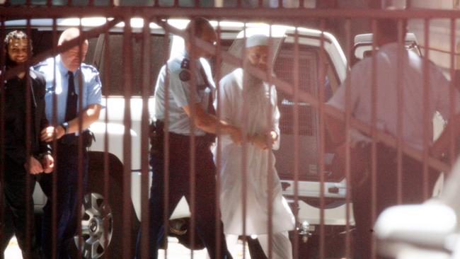 Terror suspect and Muslim cleric Abdul Naser Benbrika is escorted from the Victorian Supreme Court in Melbourne, after his conviction and sentencing on terrorism charges.