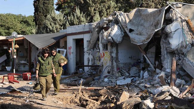 Israeli army soldiers patrol near damaged houses in kibbutz Kfar Aza in southern Israel near the Gaza Strip. Picture: AFP