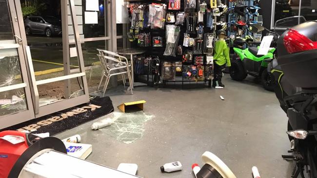 The damage left behind at Mackay Kawasaki after thieves used a stolen red LandCruiser to ram and raid the store and steal a motorbike.