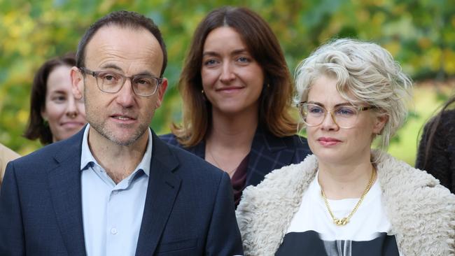 Greens leader Adam Bandt officially conceded the seat of Melbourne on Thursday, speaking to journalists alongside his wife Claudia. Picture: NewsWire/ David Crosling