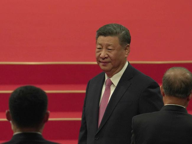 Chinese President Xi Jinping (C) and Chief Executive Sam Hou-fai arrive for the inauguration ceremony as part of the 25th anniversary of Macau's handover from Portugal to China, in Macau on December 20, 2024. (Photo by Justin CHAN / POOL / AFP)