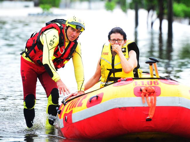 Tina Stephensen cries as she is rescued by a swiftwater Rescue Crew in Fraire St, Hermit Park. Picture: Zak Simmonds