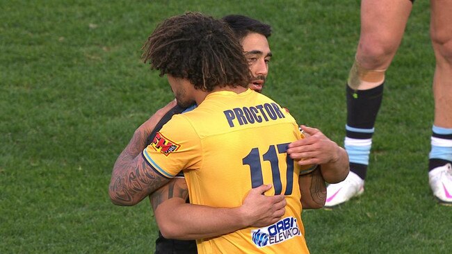 Kevin Proctor and Shaun Johnson embrace after the game.