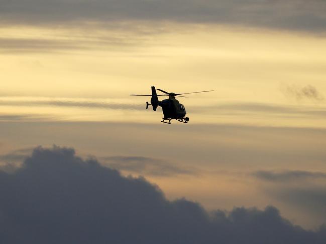 A Police helicopter flies over Gatwick Airport as they search for the Drone operator causing closure of the airport. Picture: Getty